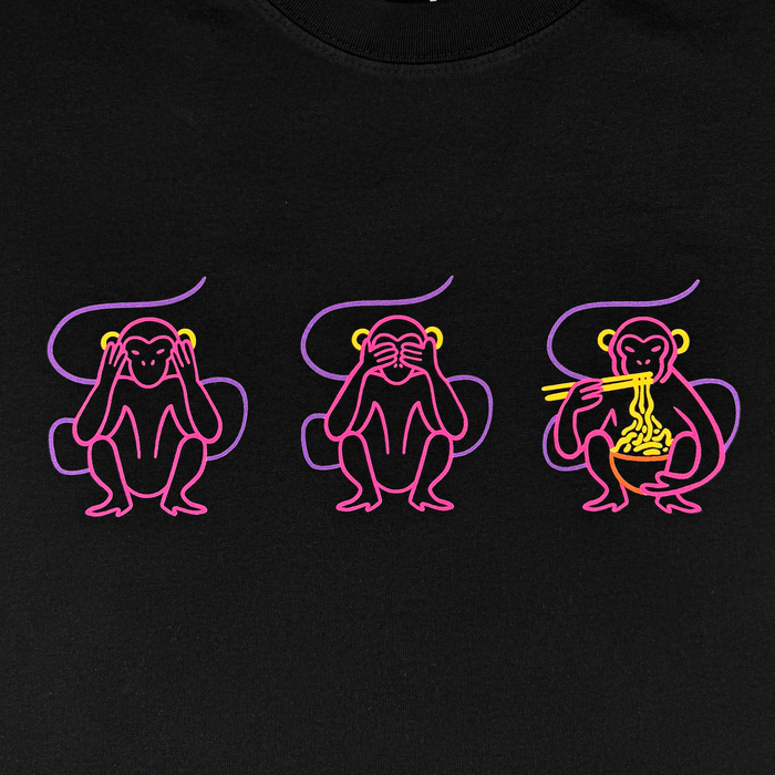 Three cartoon monkeys, outlined in neon pink and yellow, sit side by side on a black background—the first covering its ears, the second its eyes, and the third enjoying noodles with chopsticks. This playful illustration is featured on the Jo’s Modern Thai X Oaklandish Tee by Other, a heavy-weight t-shirt created in celebration of Jo’s Modern Thai.