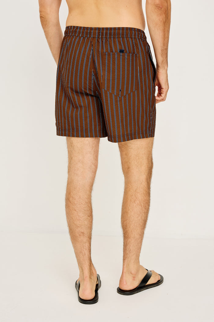 La Brea Mid-Length Swim Shorts With Adjustable Waist Drawstring Ties and Side Pockets in Rust Navy Stripe Colorway - Lower Body Back View Featured on Model