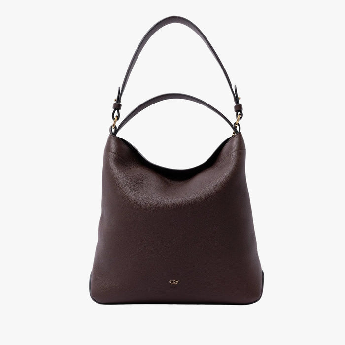 STOW London's Curve Bag in Espresso pebbled leather on a light grey background featuring the detachable shoulder strap and gold-coated stainless steel hardware