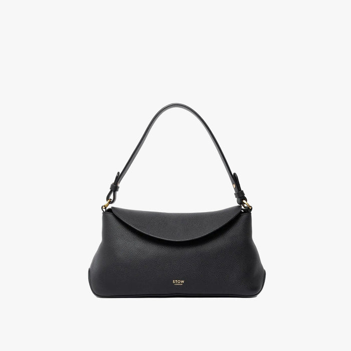 STOW London's East West in Black leather on a light grey background featuring the detachable shoulder strap with gold hardware and details