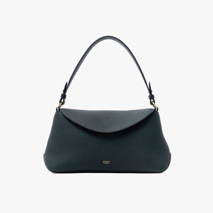 STOW London's East West in New Forest pebbled leather on a light grey background featuring the detachable shoulder strap and gold-coated stainless steel hardware