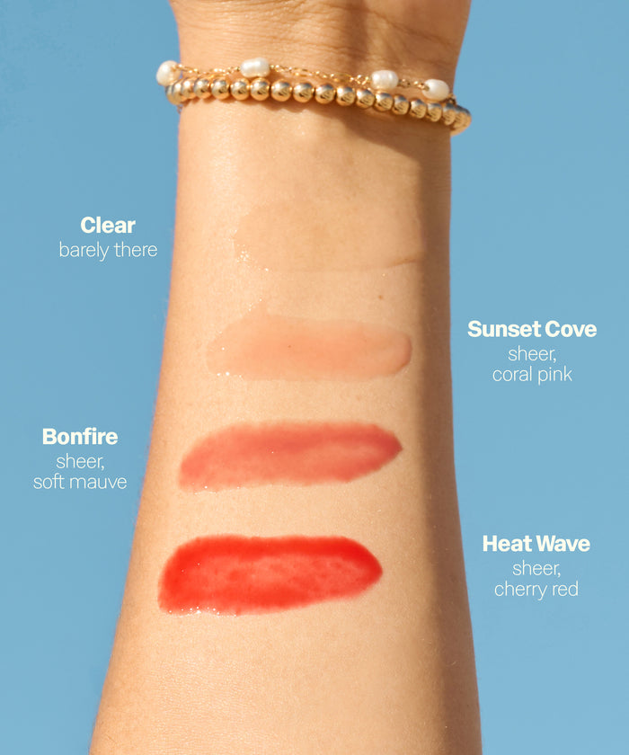 Arm swatch of Sun Bum Heat Wave SPF 30 Moisturizing Lip Balm in sheer cherry red shade on skin.