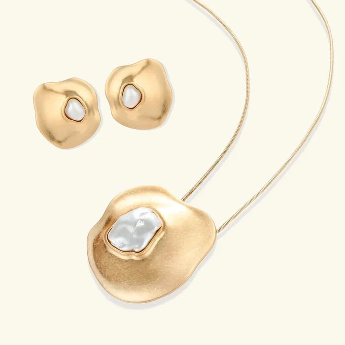 Liquid Art Sculptural Necklace set with gold-tone sculpted pendant and stud earrings, each featuring an irregular ivory inset