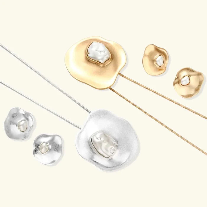 Liquid Art Sculptural Necklace with gold-tone and silver-tone sculptural pendants and matching studs, each with ivory resin insets