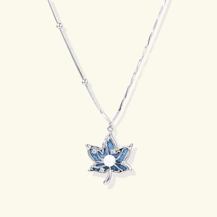 Lotus Dreams Blue Denim Pendant Necklace featuring a blue petal-shaped fabric pendant, silver-tone frame, clear accents and white pearl