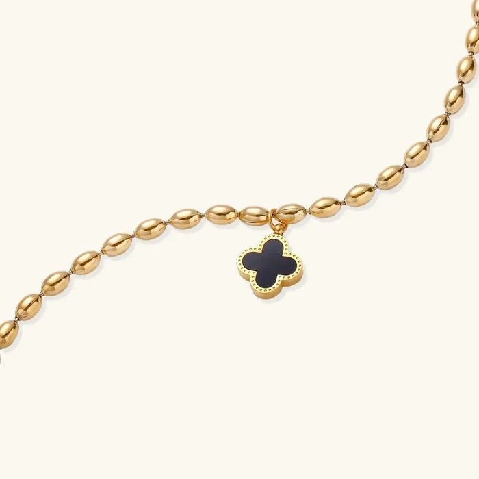 Lucky Clover 18K Gold-Plated beaded charm bracelet with a gold-tone oval-bead chain and black four-leaf clover charm