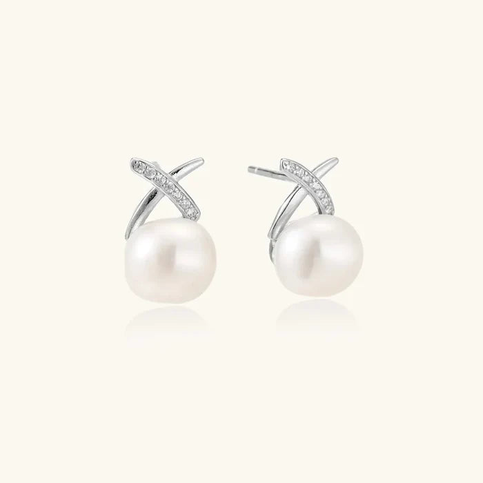 Luminous Freshwater Pearl Stud Earrings with white round pearls and silver X-shaped accents set with small sparkling stones