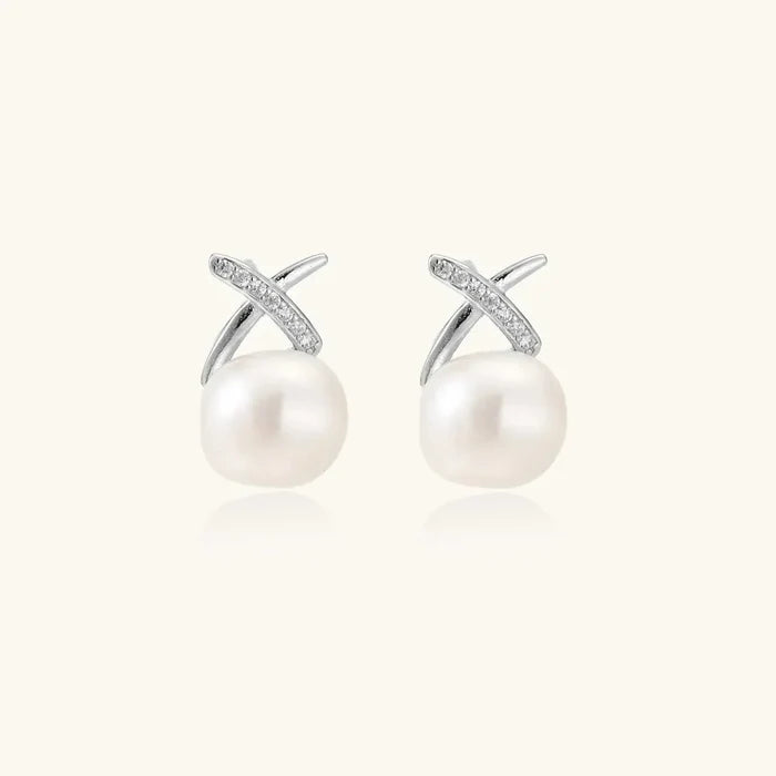Luminous Freshwater Pearl Stud Earrings with round white pearls, silver-tone X accents and pavé crystal detailing.