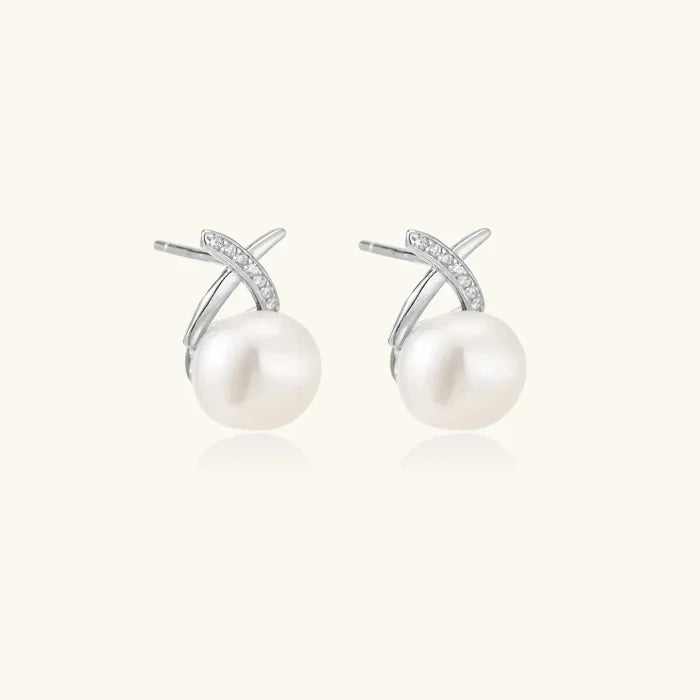 Luminous Freshwater Pearl Stud Earrings in sterling silver, with large white pearls beneath pavé crystal X-shaped accents