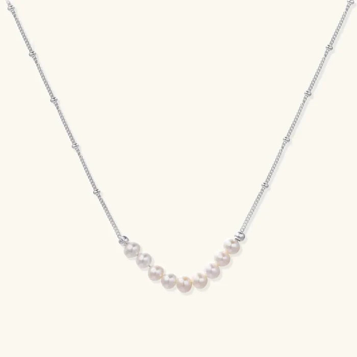 Luna Freshwater Pearl Arc Necklace with nine cream round pearls on a delicate silver-tone beaded chain