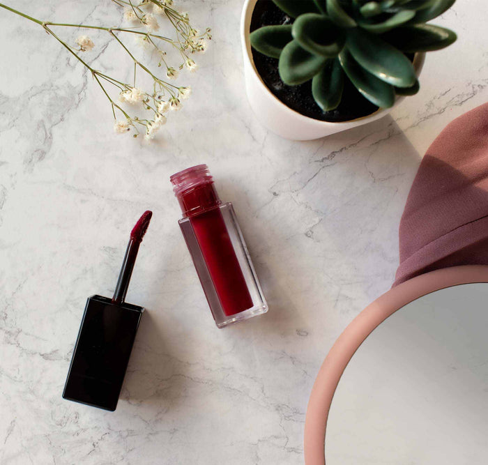 Matte Lip Stain - Dark Cherry in a clear tube with deep red pigment and a black doe-foot applicator