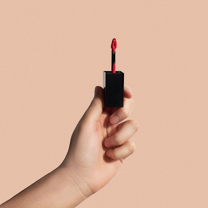 Matte Lip Stain - Dark Cherry, a deep red liquid lip stain on a black tube with a doe-foot applicator.