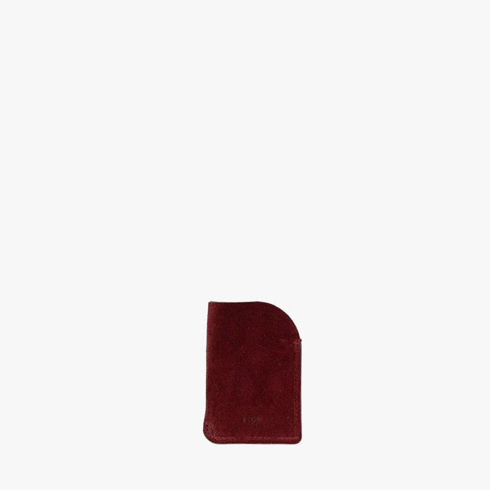STOW London's Mini Cardholder in Burgundy Suede leather on a light grey background featuring a small embossed logo on the front bottom