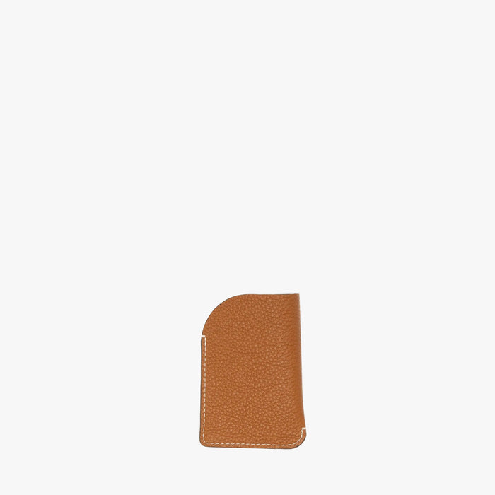 Back panel of STOW London's Mini Cardholder in Earth Tan pebbled leather on a light grey background