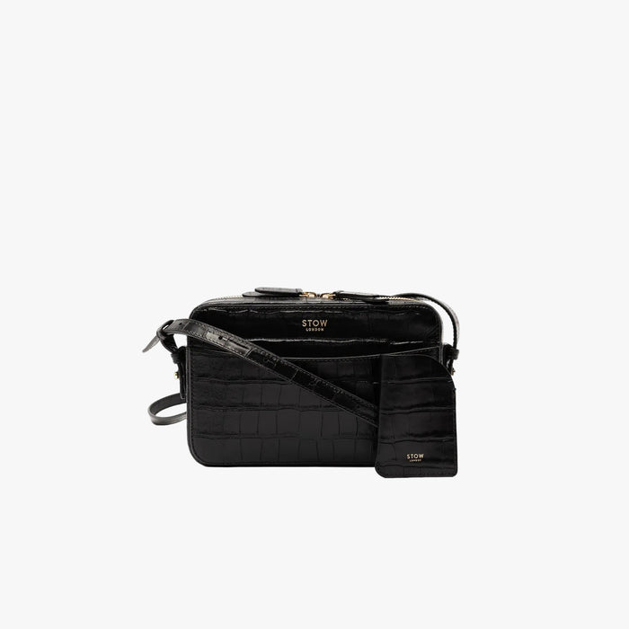 STOW London's Mini Cardholder in Black Embossed Croc leather with the matching Camera Bag on a light grey background featuring a small gold embossed logo on the front bottom
