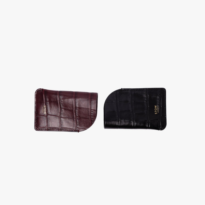 STOW London's Mini Cardholders in Black and Burgundy Embossed Croc leather on a light grey background featuring a small gold embossed logo on the front bottom