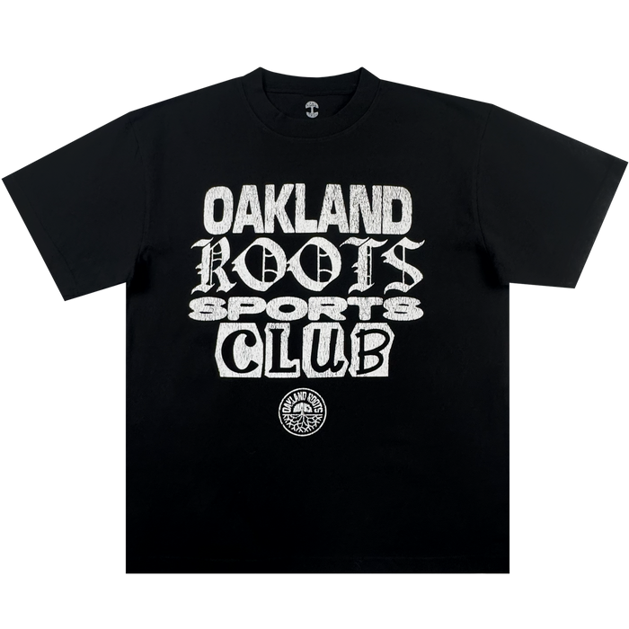 The Oakland Roots SC Multi Text SS Tee is a vintage black oversized t-shirt with bold white text in multiple fonts and a circular tree logo, displayed flat on a plain white background.