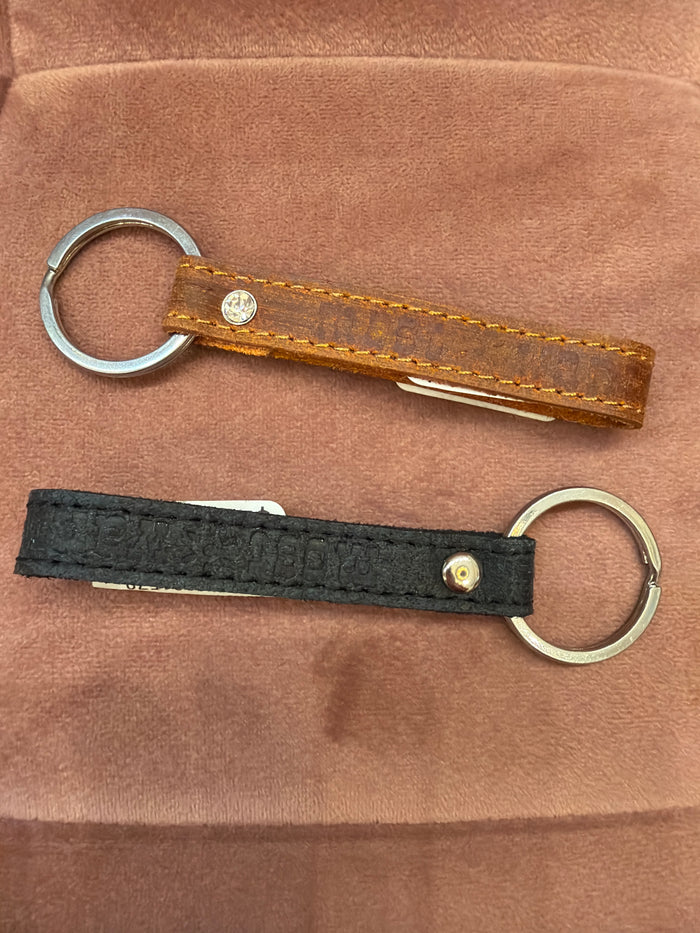 Most Wanted USA leather key strap with metal keyring, stylish and durable key chain accessory.