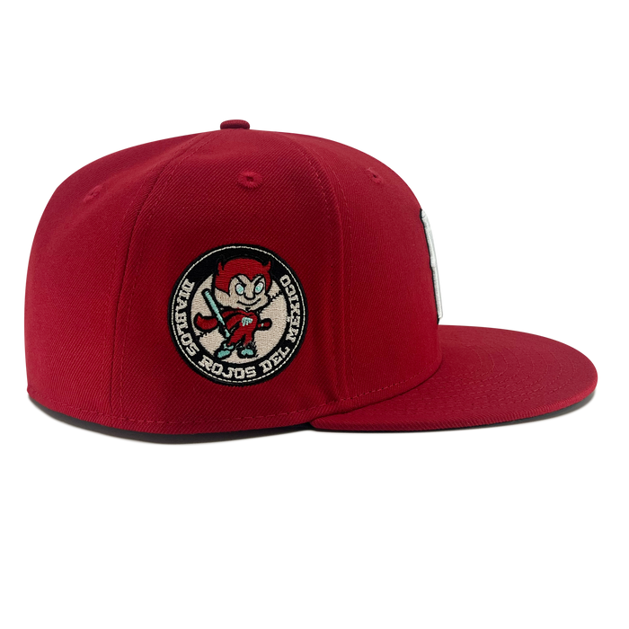 Right side view of red diablos 59fifty  fitted hat with Diablos patch on wearer's right.