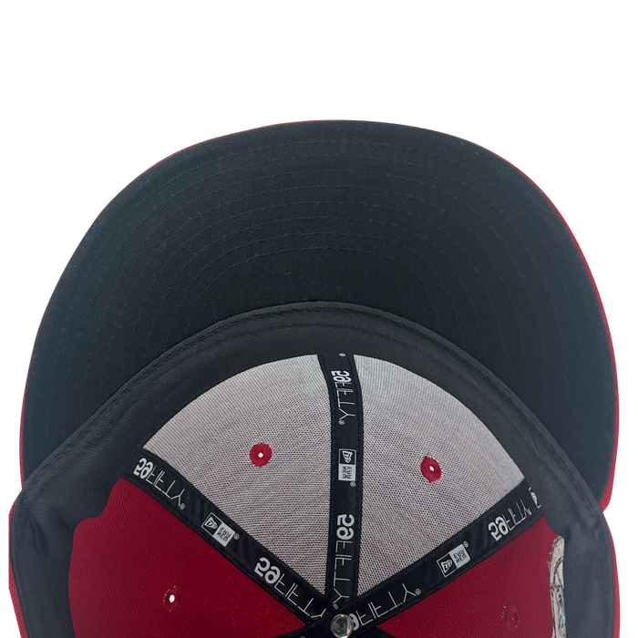 View under bill of red 59fifty fitted hat with Diablos logo in white embroidery.