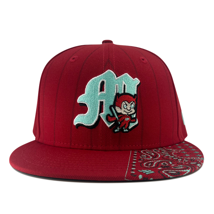 The New Era Diablos Pinstripe 59FIFTY Cap by Other showcases a vibrant red color with pinstripes and features an embroidered pale blue “A” alongside a cartoon devil on the front. The right side of the brim is adorned with an eye-catching red and white paisley bandana pattern, all set against a plain white background.