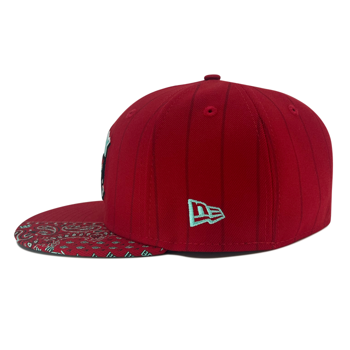 A New Era Diablos Pinstripe 59FIFTY Cap by Other, featuring a red pinstriped design with subtle vertical lines, a white New Era logo embroidered on the side, and an underbrim displaying a white paisley bandana pattern. The cap is shown from a side angle against a plain white background.