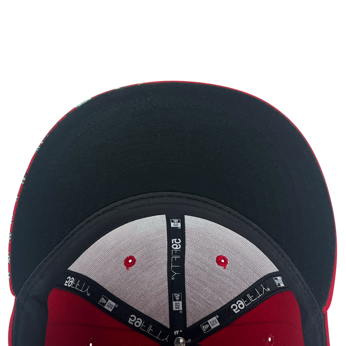 Here’s the revised sentence using your product data: A top-down view of the inside of the New Era Diablos Pinstripe 59FIFTY Cap by Other, featuring a black brim with a red edge, grey interior panels accented in red and black, and inner seams lined with black tape bearing white “YTTL265” text evoke its classic pinstripe style.