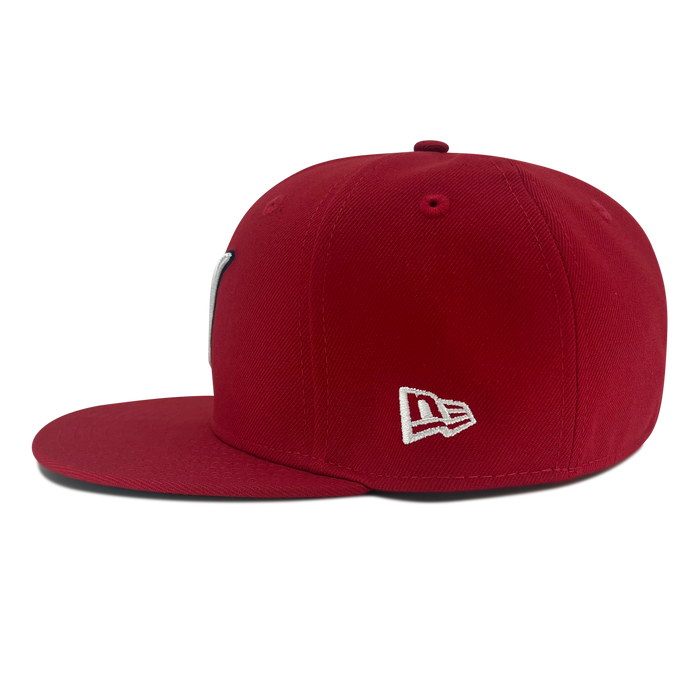 Left side view of red New Era 59fifty fitted hat with LMB embroidered logo.