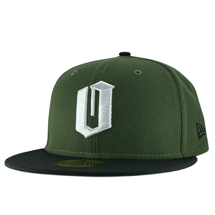 A green New Era Official 59FIFTY Fitted Cap from the brand Other, this fitted hat features a black flat brim and a prominent white embroidered “U” on the front. The signature New Era logo is stitched in black on the left side, while ventilation eyelets on the top ensure breathability.