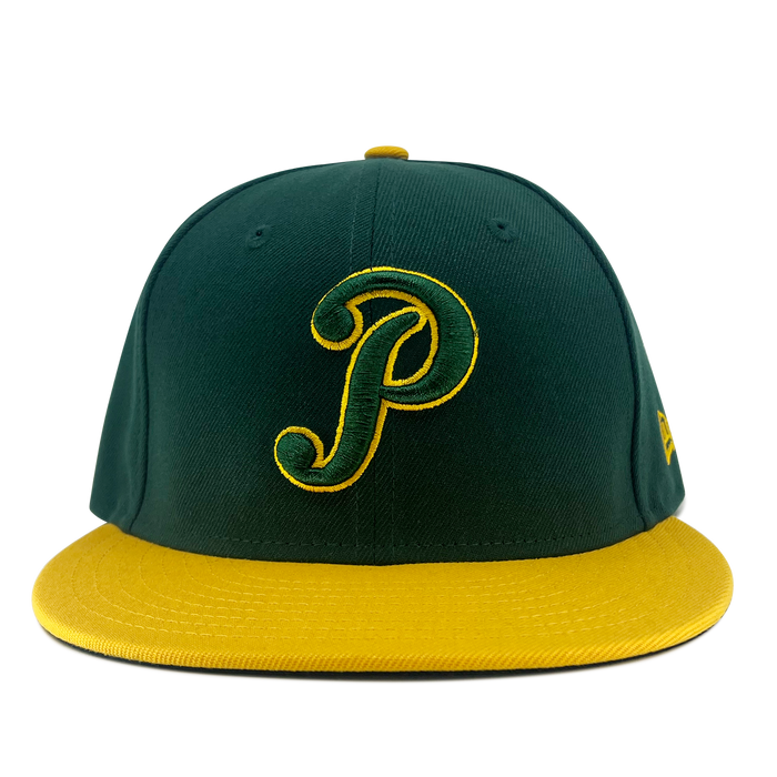 A New Era Pericos Home 59FIFTY Cap by Other is displayed against a plain white background. This fitted baseball cap features a dark green crown with a yellow brim and button. The front showcases a large, cursive yellow “P” outlined in green, while the left side is adorned with a small yellow New Era logo.