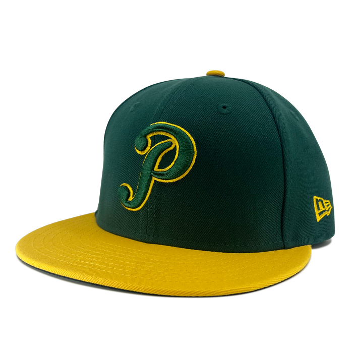 A New Era Pericos Home 59FIFTY Cap by Other is displayed on a white background. This fitted baseball cap features a dark green crown and a yellow bill. The front showcases a large, stylized yellow letter “P,” while the side is accented with a yellow New Era logo.