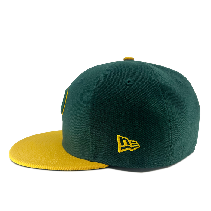 The New Era Pericos Home 59FIFTY Cap by Other features a green fitted design with a vibrant yellow brim and a yellow New Era logo embroidered on the side, shown against a plain white background.