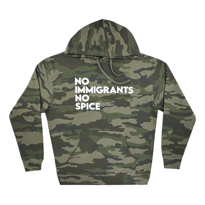 The Oaklandish NINS Hoodie features a green camo pattern on the sleeves, hood, and body, a front pocket, drawstring hood, and bold white “No Immigrants No Spice” text on the chest celebrating spicy pride and immigrant rights.