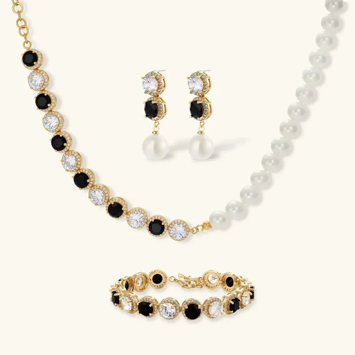 Noir Luxe Black & Clear three-piece jewelry set with gold-tone black and clear stones, white pearls, and matching necklace, earrings and bracelet