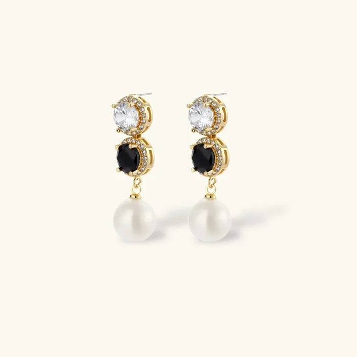 Noir Luxe Black & Clear drop earrings feature gold-tone settings, clear and black round stones, and white pearl drops.