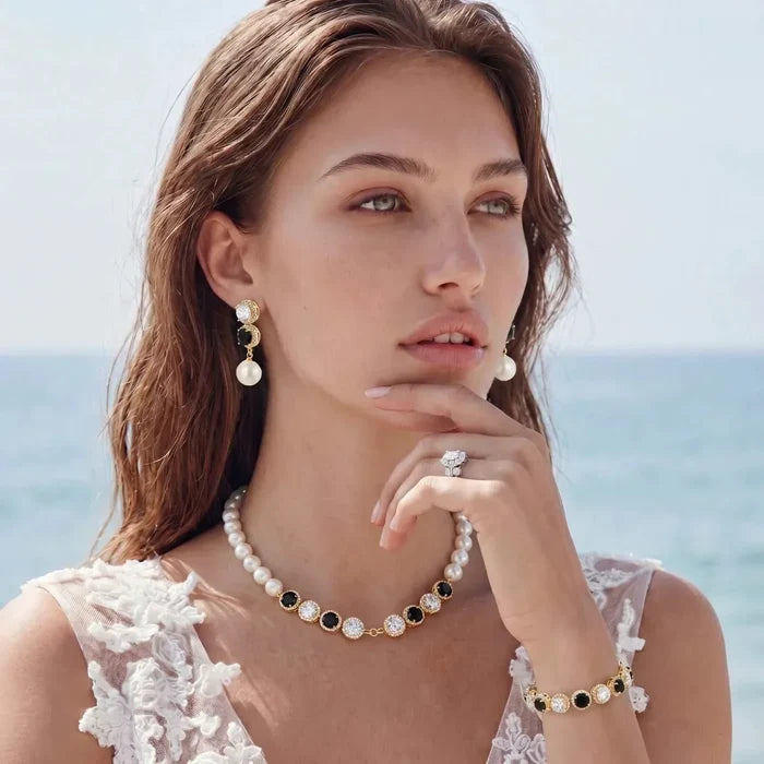 Noir Luxe Black & Clear jewelry set with a gold-tone pearl necklace, black and clear stones, drop earrings and bracelet