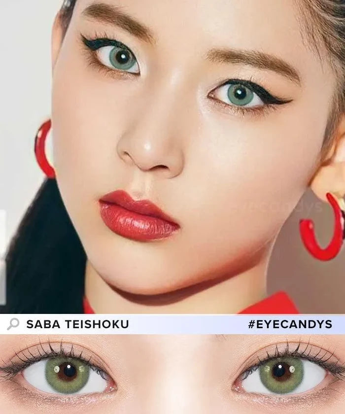 A fair-skinned woman with green eyes, bold eyeliner, red lipstick, and red hoop earrings wears N's Collection Saba Teishoku Green coloured contacts by N's Collection. A close-up highlights the product inspired by Naomi Watanabe.