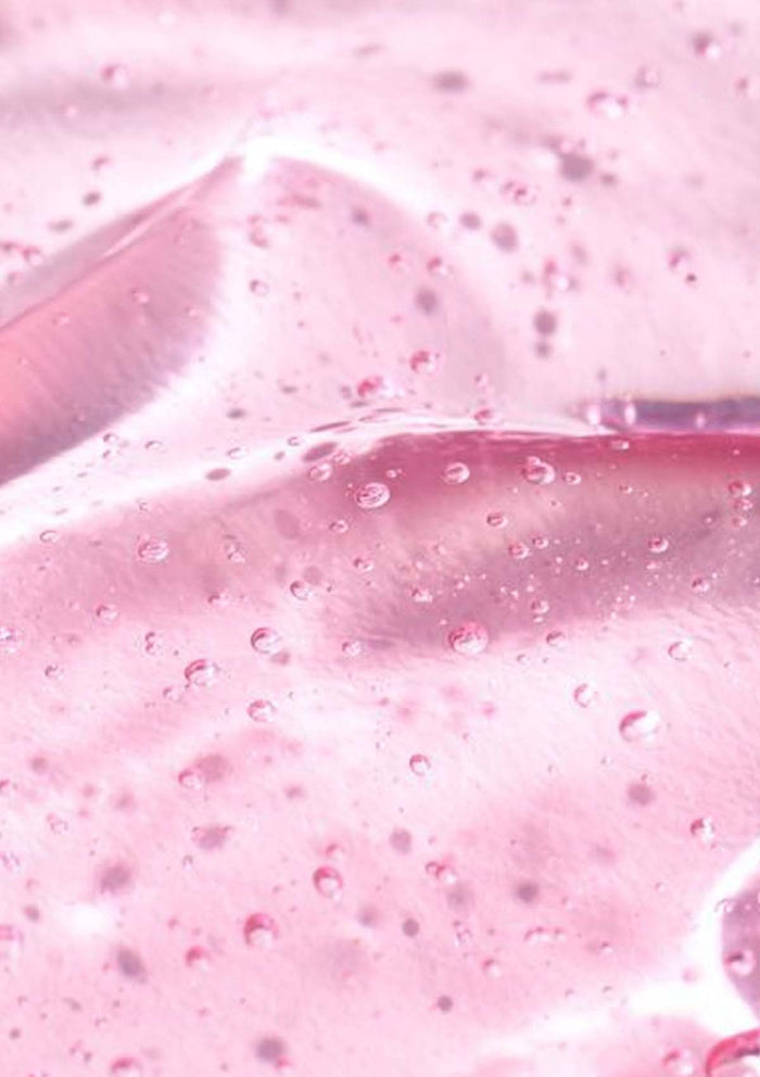 Close-up of pink slime with bubbles and a knife blade.