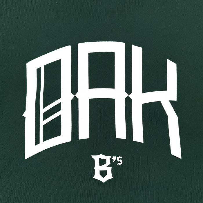 The OAK Ballers Hoodie by Oakland Ballers features bold white “OAK” text and ornate “6’s” on a dark green background, creating a modern, sporty design inspired by the team’s baseball heritage.