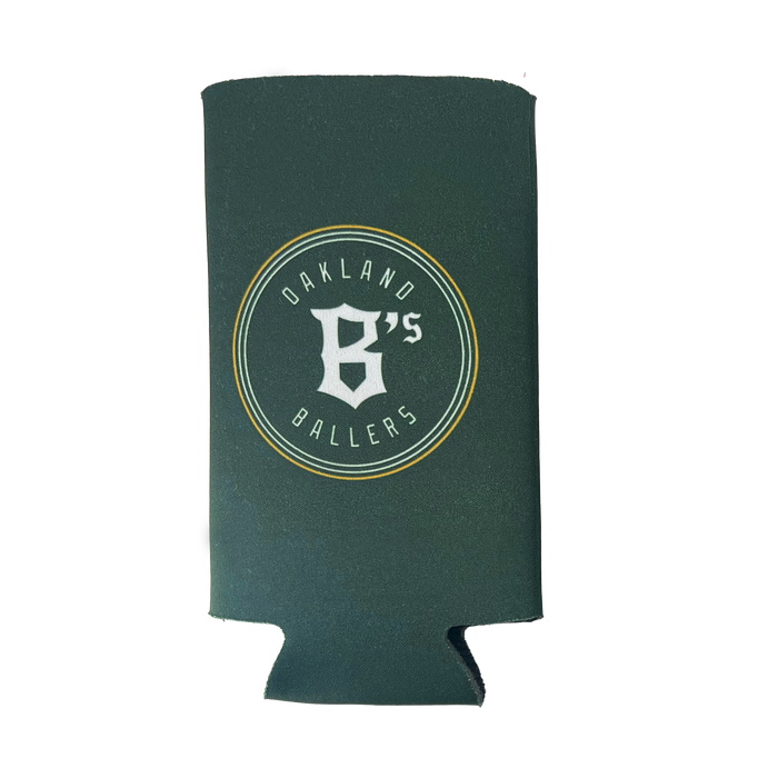 The Oakland Ballers 16oz Can Cooler is green and features a prominent white circular logo in the center. The logo displays "Oakland Ballers" in uppercase letters encircling a large stylized "B's," symbolizing the professional baseball team from the Pioneer League. Additionally, the cooler includes a convenient cutout at the bottom designed to hold a can or bottle securely.