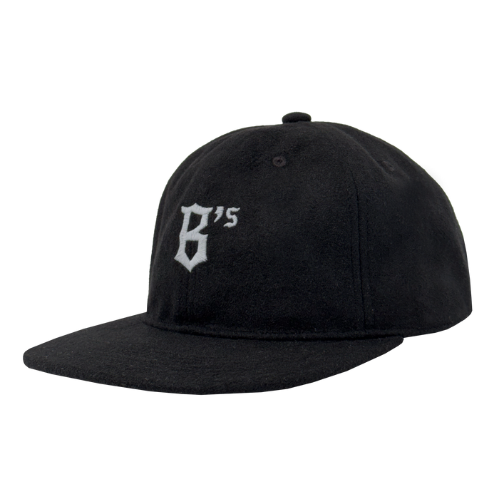 The Oakland Ballers B Strapback is a black flat-brim hat with "B's" in white old English font embroidered on the front, adjustable strapback, top button, and visible stitching. Brand: Oakland Ballers.
