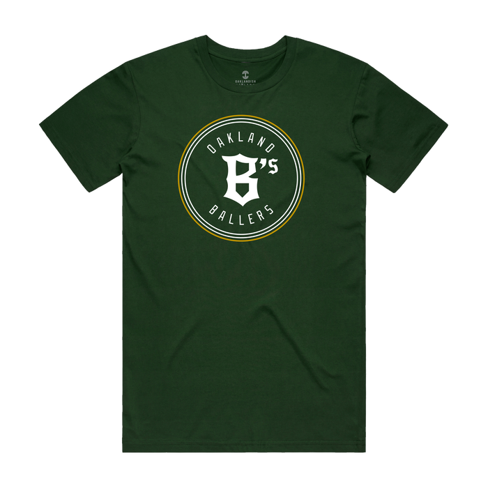 Green Oakland Ballers Classic Tee with "Oakland B's Ballers" logo in white and yellow text within a circle, capturing the spirit of the Pioneer League baseball team. The central design adds sporty, casual flair.
