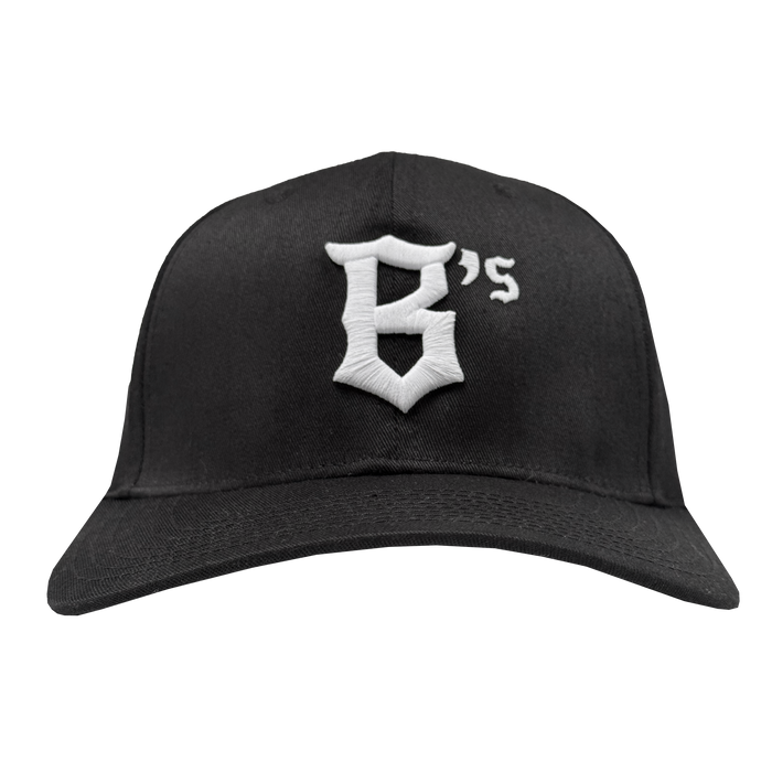 The Oakland Ballers Flexfit Cap by Oakland Ballers is a black baseball hat with a white, Gothic-style embroidered “B’s” on the front, featuring a curved brim and structured crown. Shown against a white background.