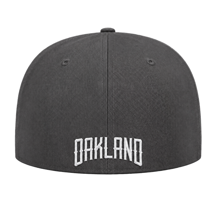 An Oakland Ballers Logo Hat in dark gray is pictured from the back, showcasing “OAKLAND” embroidered in bold, white, uppercase letters near the bottom edge—a tribute to the proud legacy of the Oakland Ballers pro baseball team. The cap includes two small ventilation holes on each side and a button on top. The background is plain white.