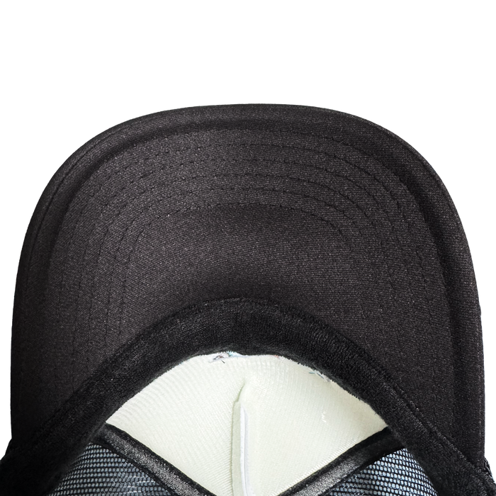 Close-up of the Oakland Ballers Pride Trucker by Oakland Ballers, showing the black brim underside, stitching, inner white foam lining, and part of the black sweatband and mesh against a plain light background.