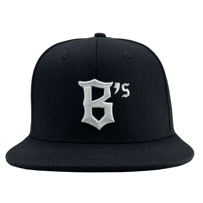 The Oakland Ballers Snapback, branded by Oakland Ballers, is a black baseball cap with a flat brim. It features a large white letter "B" followed by a small white apostrophe and "s," all embroidered in a bold, stylized font on the front panel. The plain white background accentuates the cap's design and color details, inspired by the iconic Oakland Ballers professional baseball team.