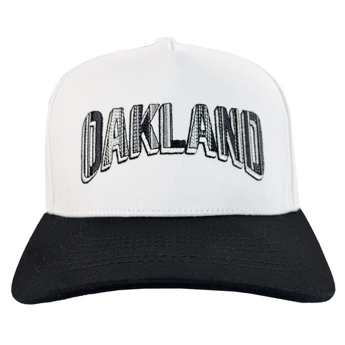The Oakland Ballers' Oakland Beisbol 5 Panel Cap features a white body with a black bill and bold "OAKLAND" embroidery on the front, shown facing forward on a plain white background.