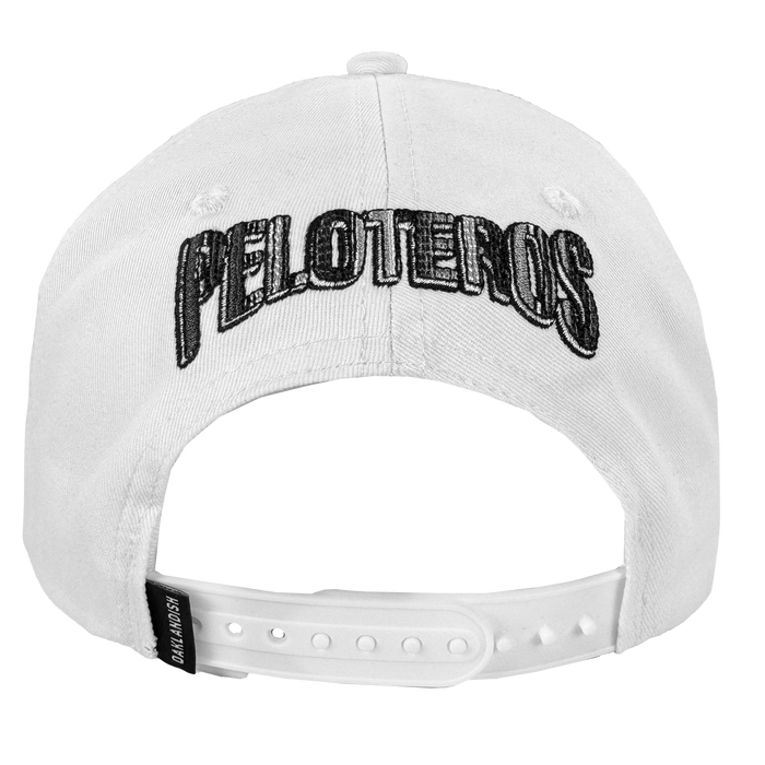 The Oakland Beisbol 5 Panel Cap by Oakland Ballers is a white snapback featuring bold black "PELOTEROS" embroidery on the back, an adjustable plastic closure, and a small black "BALLTAILORS" tag at the bottom.
