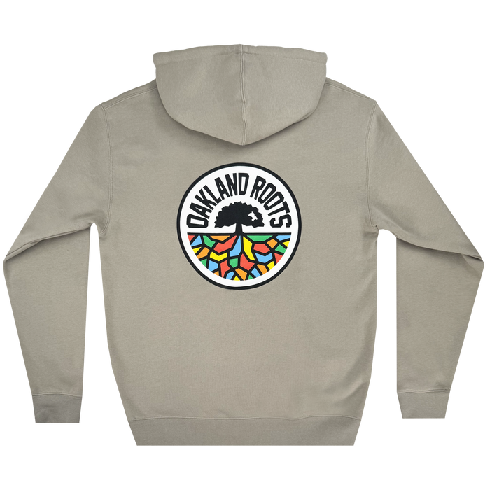 The Oakland Roots SC Classic Hoodie by Oakland Roots SC is a beige sweatshirt with a colorful back emblem displaying a black tree and multicolored roots in green, orange, blue, and red. The words "OAKLAND ROOTS" encircle the design.