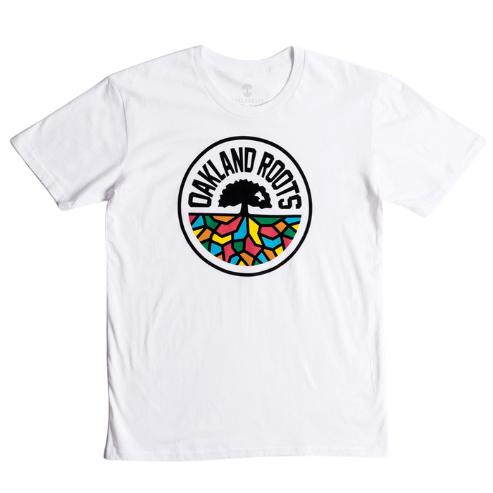 The Oakland Roots SC Classic Tee from Oakland Roots SC showcases a striking circular logo in the center. At its heart is a black tree with sprawling roots, accompanied by the text "Oakland Roots" elegantly arched above it. The roots branch out into vibrant sections of red, blue, green, and yellow, forming a stained-glass effect that symbolizes the club's commitment to social good.
